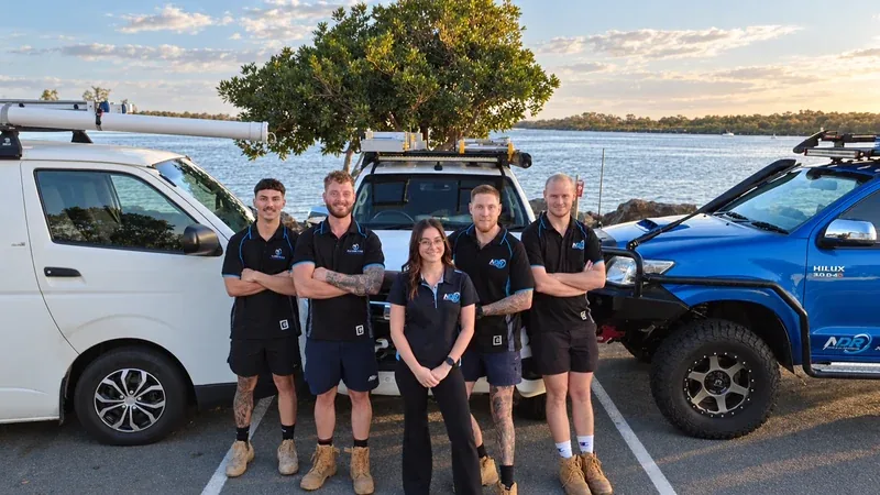 NDR team standing together with their work vehicles